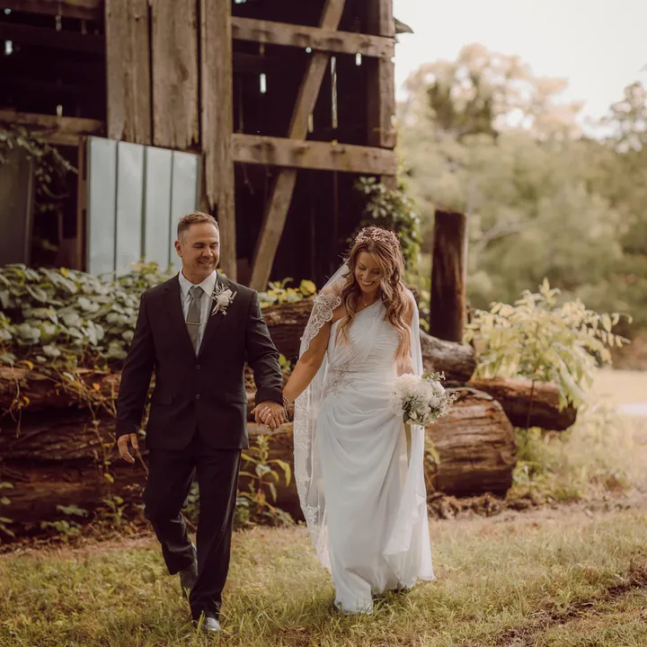 Mark and Megan Holshouser holding hands on their wedding day.
