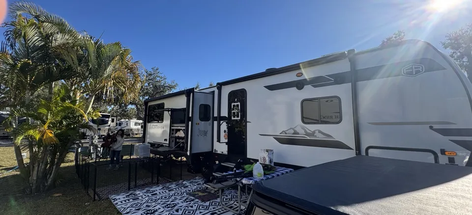 Mark and Megan’s travel trailer set up at a campsite.